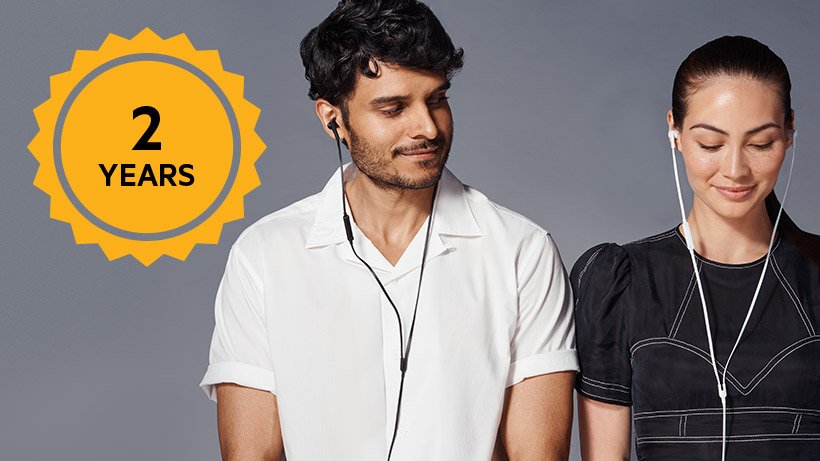Photo of a couple with SOUNDFORM headphones with a 2-Year warranty icon overlaid