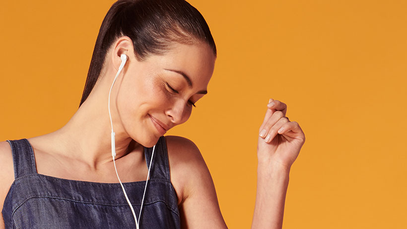 Woman snapping her fingers while listening to music
